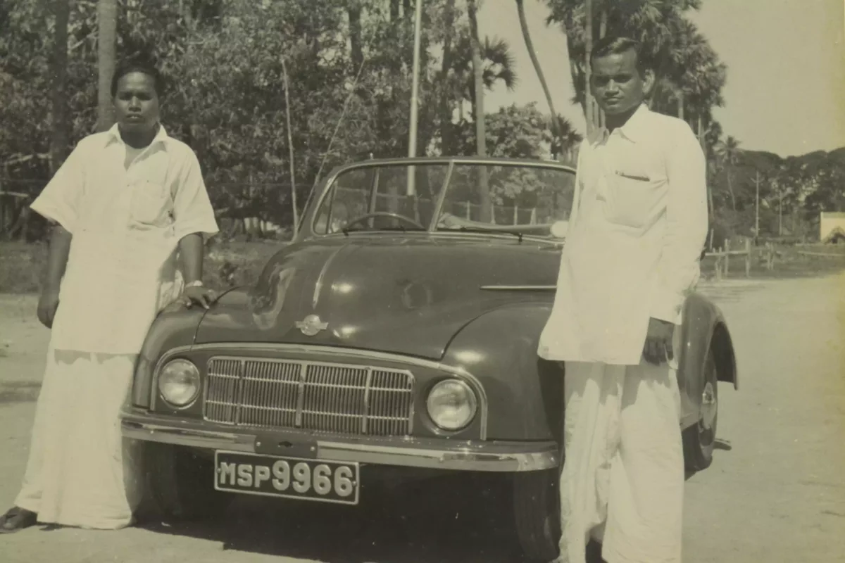 Two Indian rich trader from south India chettinad region standing with their classic vintage car