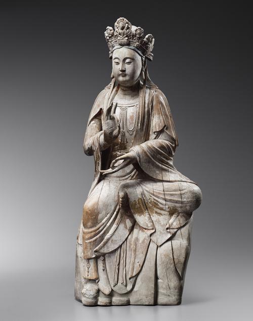 Stone sculpture of chinese woman sitting in meditation