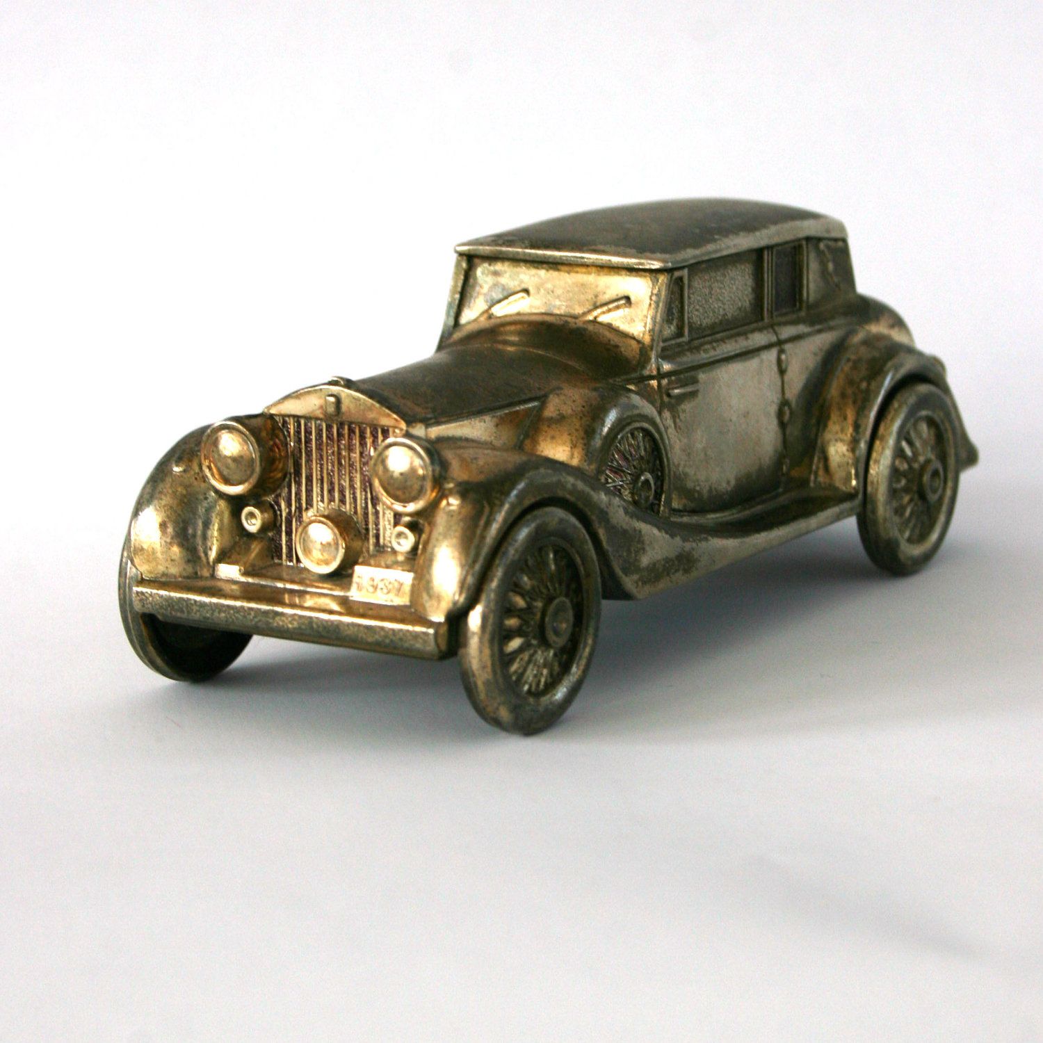 Vintage tin toy car in classic rusted gold color