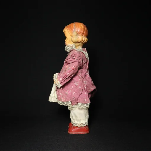 doll tin toy side view
