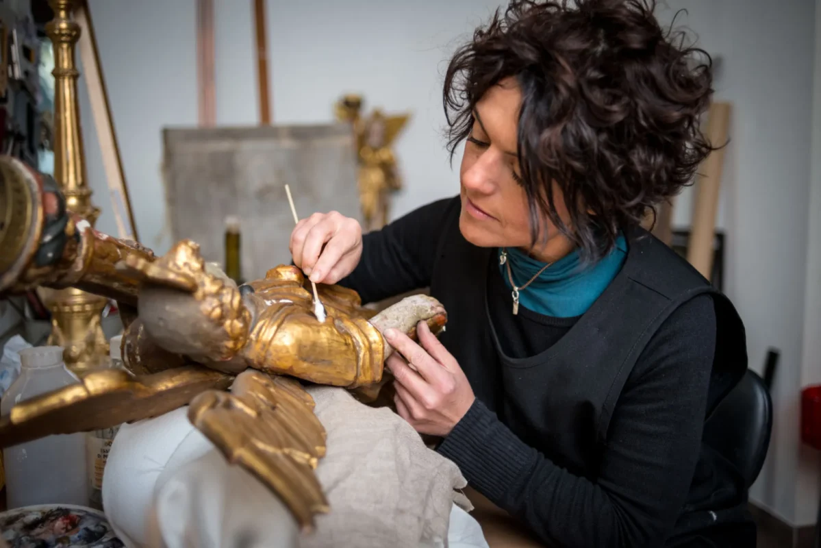 A woman working on sculpture restoration